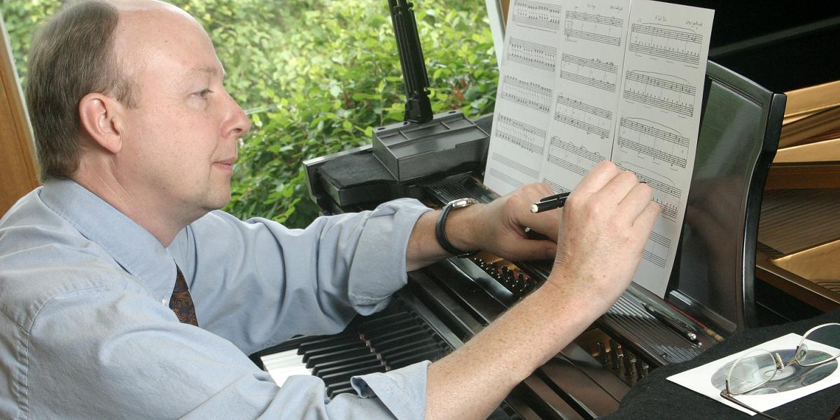 D. Geoffrey Bell composing at the piano in 2004